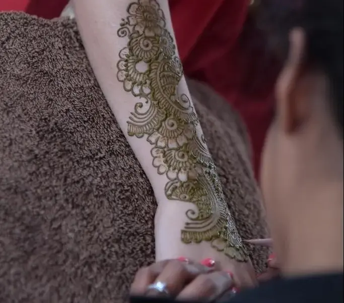 Henna application in progress